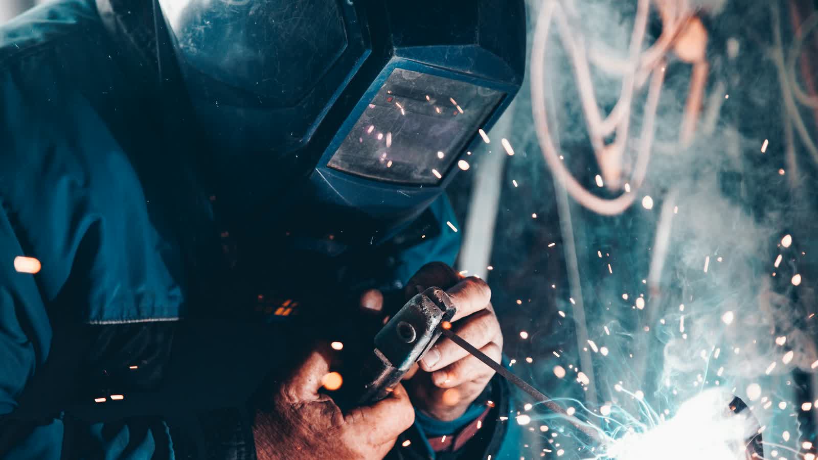 Technician carrying out hot work on ship structure